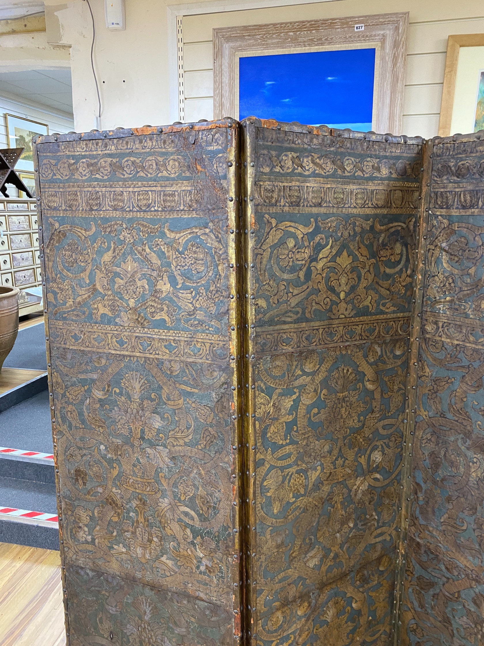 A 19th century French studded leather four fold screen, each panel width 49cm, height 182cm